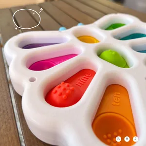 Close-up of baby sensory flower toy with colorful silicone bubbles and numbered engravings