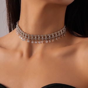 Detail of silver layered choker necklace with hollow mesh chain and crystal teardrop pendants
