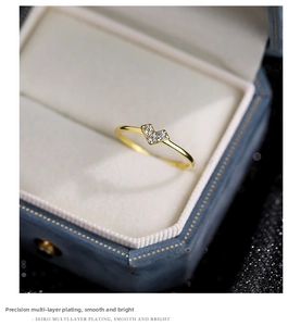 Close-up of gold heart ring with micro-pave cubic zirconia on elegant jewelry box