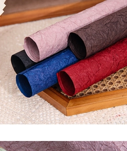 Detailed view of assorted colors textured wrapping paper rolls for flower arrangements