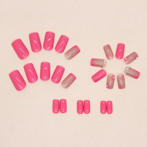 Pink daisy press-on nails with small rhinestones and French tip square design
