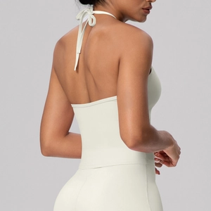 Detailed back view of a white halter neck sports top featuring secure cross straps