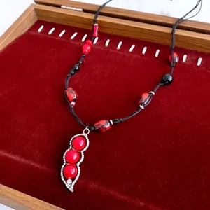 Vintage zircon beaded flower necklace with red stones and pea-shaped pendant