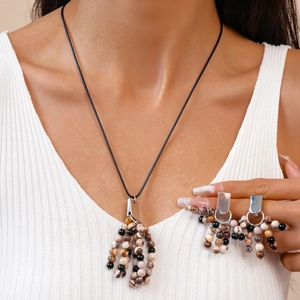 Vintage ethnic style beaded tassel necklace and matching earrings set on a model