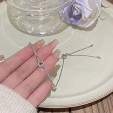 Detail of adjustable silver chain bracelet with micro-pave zircon ring element
