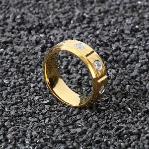 Detailed view of an 8mm gold titanium ring featuring sparkling white cubic zirconia stones
