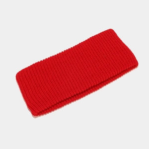 Close-up of red ribbed knit headband showing thick elastic fabric and detailed texture