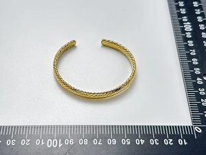 Detailed top view of 18K gold-plated C-shaped cuff bracelet with rope twist texture