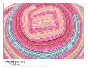 Close-up of spiral stitching and colorful woven straw texture on the sun hat crown