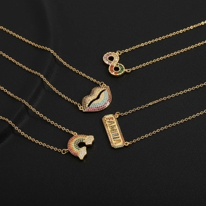Set of four gold necklaces featuring crystal-studded infinity, lips, cloud, and Familia charms
