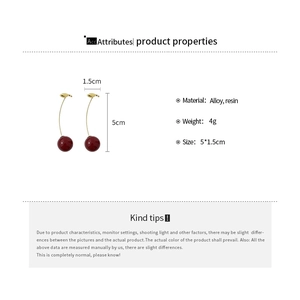 Detailed view of red resin cherry earrings with golden alloy leaves and measurement specs