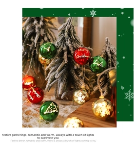 Macro view of Christmas LED baubles with Merry Christmas prints on snow and wood background