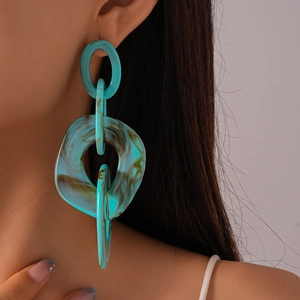 Macro detail of lake blue marble textured acrylic geometric triple loop earrings