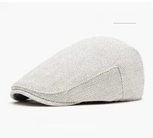 Detail shot of the grey white herringbone tweed fabric on a classic vintage ivy cap