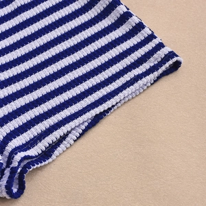 Close-up of blue and white striped knit fabric showing fine stitching and texture detail