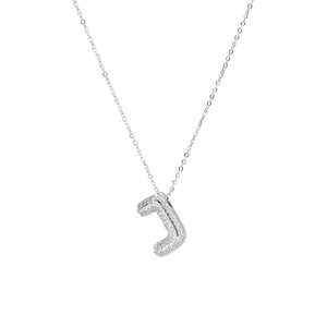 Macro shot of silver letter J pendant with shiny pavé cubic zirconia setting