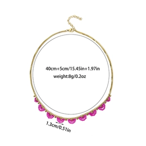 Golden stainless steel necklace with pink crystal beads in geometric half-circle design