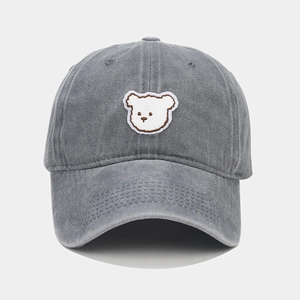 Close-up of the detailed white bear embroidery on this gray washed cotton baseball cap