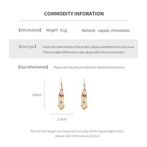 Detail view of gold-plated gourd tassel earrings with dimensions and material specs