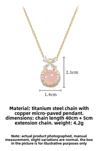 Detail view of titanium steel necklace with bow pendant and pink stone showing dimensions