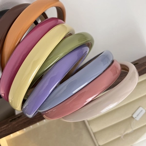Set of colorful glossy headbands in various vibrant shades like orange and blue