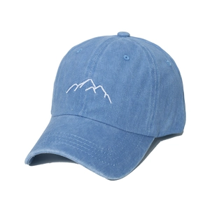 Detail of blue washed cotton baseball cap with white mountain peak embroidery