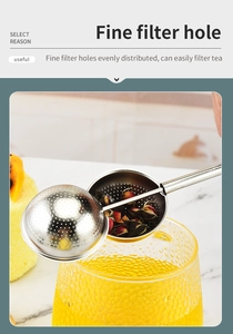 Detail of stainless steel tea infuser with fine mesh holes filtering tea in a glass cup