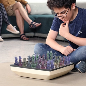 Creative resin crystal chess set with colorful translucent pieces and beige silicone board