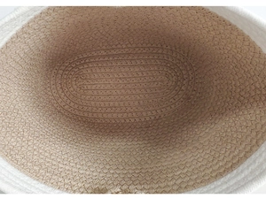 Macro shot of circular woven pattern detail on beige and tan cotton rope basket