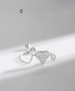 Macro shot of S925 sterling silver chain ring featuring a diamond-shaped pave charm
