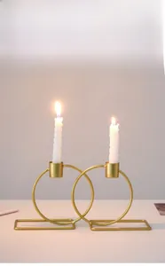 Detail of interlocking gold rings candle holder with two long rectangular bases