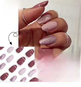 Detail of round press-on nails in dusty rose and pink glitter finishes with matte texture