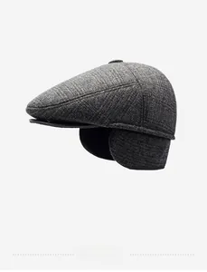 Detailed side view of grey tweed flat cap with fold-out ear flaps for winter warmth