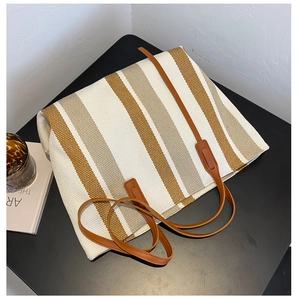 Detailed top view of large canvas tote bag with brown and beige vertical stripes
