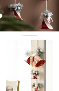 Macro shot of red Christmas bells with silver bows and pine needles for holiday decor