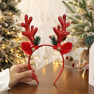 Close-up of red sequined reindeer antlers headband with bells and festive decorations