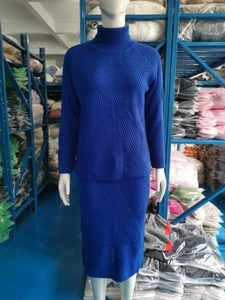 Detail of dark blue knit sweater and skirt set showing vertical ribbed texture patterns