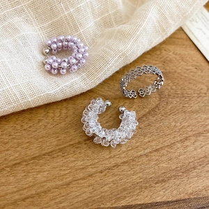Detailed view of elegant floral beaded ear cuffs and silver engraved metal ear clips
