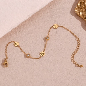 Detail of 18K gold plated bracelet featuring daisy charms and sparkling white zircons