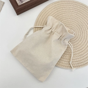 Minimalist cream canvas drawstring storage bag with natural cotton cords for jewelry