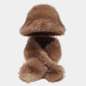 Detail of warm brown faux fur winter set featuring a fluffy bucket hat and cross scarf