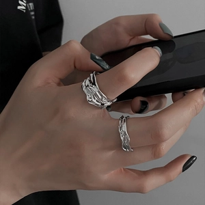 Irregular geometric open rings with molten lava texture in silver minimalist style