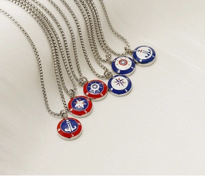 Detail of nautical compass pendants with anchor and star designs in colorful enamel finish