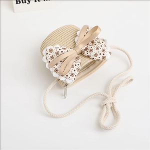 Close-up of heart-shaped straw bag featuring large floral bow and lace trim details