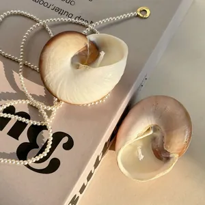 Macro detail of natural seashell scented candles with white wax on vintage books
