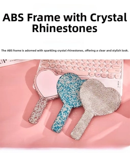 Detail of heart-shaped handheld mirrors with luxury rhinestones in pink, blue, and silver