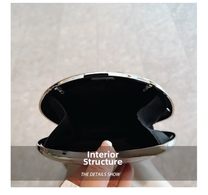 Internal structure of silver metallic oval evening clutch bag with black fabric lining