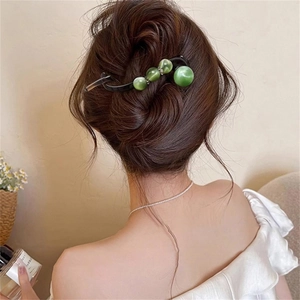 Elegant green cat-eye resin hair clip styled in a low bun for a forest-inspired aesthetic