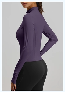Detail of slim fit purple sports jacket and black leggings for women fitness wear