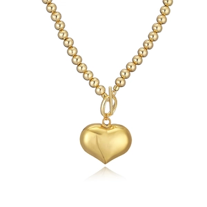 Golden bead necklace with chunky heart pendant and OT toggle clasp closure